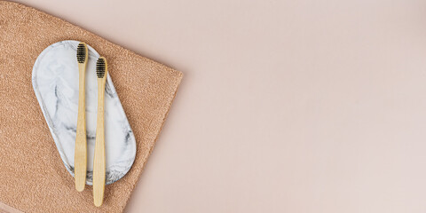 Banner with Bamboo eco-toothbrushes on a stand on a light background. Vertical photo for eco-friendly consumption, dental health, for dental clinics and dentists. Copy space for text