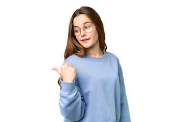 Teenager girl over isolated chroma key background pointing to the side to present a product