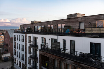 Fototapeta premium Landscape view over modern apartment blocks and the urban skyline during the morning golden hour, Jette, Brussels, Belgium