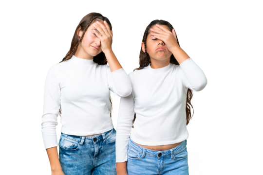 Friends girls holding gift and a birthday cake over isolated chroma key background with surprise and shocked facial expression