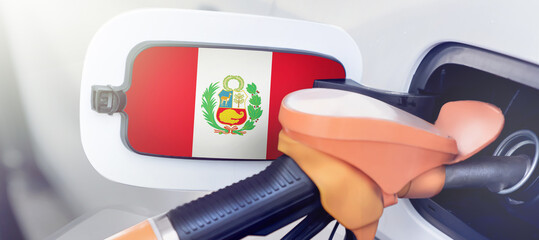 The flag of Peru on the lid of the gas tank of a car at a gas station in close-up. High or low gasoline prices at Peruvian gas stations. Gasoline prices are rising due to a shortage of diesel fuel
