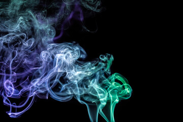 Colorful smoke swirls creating captivating patterns against a dark background in a mesmerizing display of movement and light