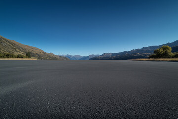 Scenery of highway by the lake and distant mountains in New Zealand