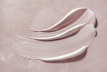 Pink beige cosmetic kaolin clay mask swatch smudge on gray background