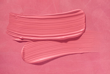 Lipstick or creamy bluster smudge swatch isolated on pink background