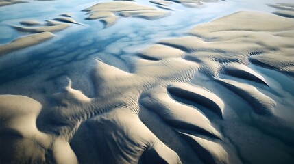 Patterns and textures of sand and water at low tide