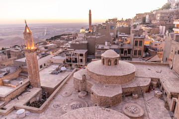 Sunset view of the old town in Mardin with Emir Hamami baths in the foreground, Turkey