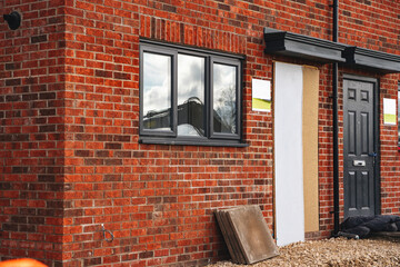 Newly constructed brick building featuring modern design with large windows located