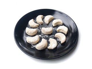 Kue putri salju or Snow princess cookies on plate isolated on white background 