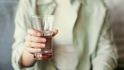 Woman holding a glass of water
