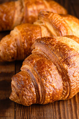 Delicious snack croissant on wooden background