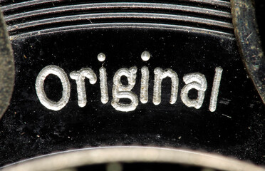 An old, hundred-year-old engraved inscription on an antique lens