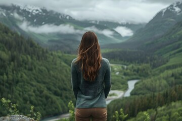 Naklejka premium Woman Looking at Mountain Landscape View with Green Forest and River