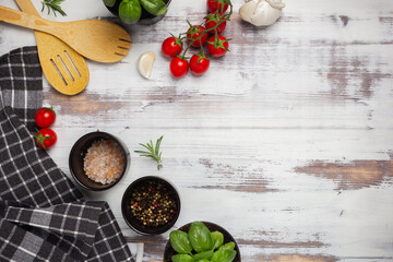 Food background with spices, herbs and utensil on white background.