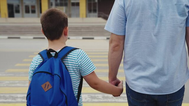 cross road zebra crossing, child crosswalk, Father and son walking together, school journey, parent and child bonding, crossing the street, back to school moment, dad holding son's hand, childhood