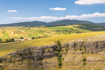 View of country in Bosnia and Herzegovina, Europe. Scenic vista: rolling hills, meadows, and...