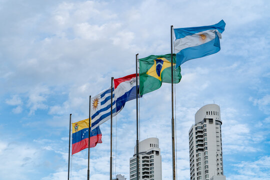 Grupo de banderas ondeando al viento: Argentina, Brasil, Paraguay y Uruguay. Convenci&oacute;n del Mercosur
