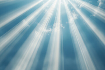 Fototapeta premium Beautiful rays of sunlight piercing through a clear blue sky, creating a serene atmosphere.
