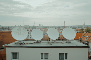 Arafed view of a city with a lot of satellite dishes on top of it