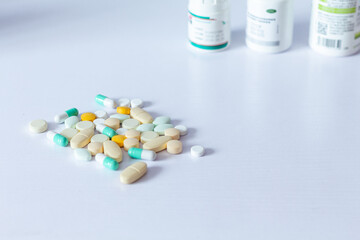 pills, capsules and bottles on white background