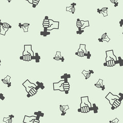 Hammer in hand solid seamless pattern, repair service theme. Vector graphics. Human hand with hammer sign background, filled with glyphs icon.