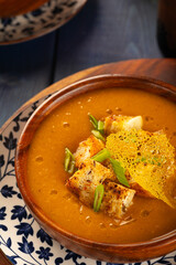 Red Lentil Soup with ingredients on wooden background, top view, copy space. Traditional turkish or arabic lentil and vegetable spicy soup, healthy vegan food.