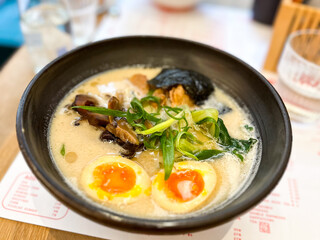 Miso Ramen Asian noodles soup with beef, egg on a table
