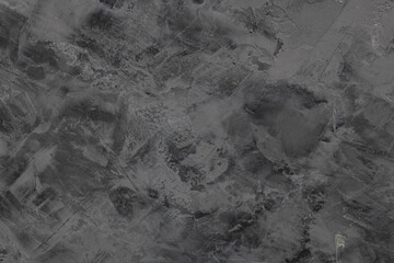 Abstract dark gray texture with subtle patterns and variations, creating moody atmosphere