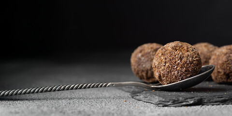 Decorating of artisan chocolate truffle candies with berry and fruit filling on dark background from confectionary. Handmade or handcrafted bonbons, chocolatier concept. Horizontal banner, copy space © alma.photo