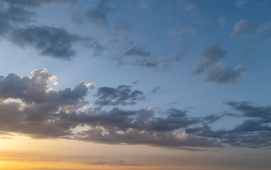 Beautiful sky with clouds during sunset, showcasing vibrant colors and serene atmosphere. Ideal for nature and outdoor-themed projects.