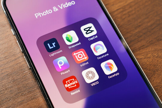 Poznan, Poland - March 12, 2025: smartphone screen with popular photo and video editing apps including lightroom, snapseed, capcut, facetune, picsart, inshot, remini, vsco, and faceapp
