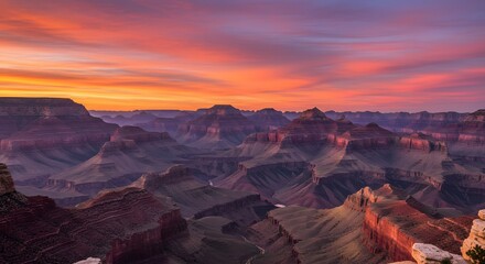 Grand canyon landscape view at sunset with vibrant orange and pink sky over the canyon ridges