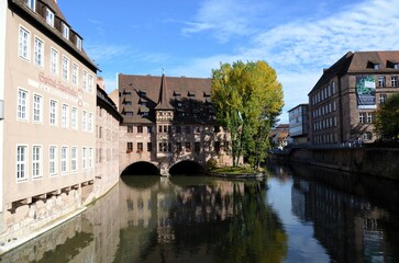 Obraz premium Nuremberg, Germany 10.17.2019: Hospice of the Holy Spirit (Heilig-Geist-Spital) in the center of Nuremberg on the banks of the Pegnitz river