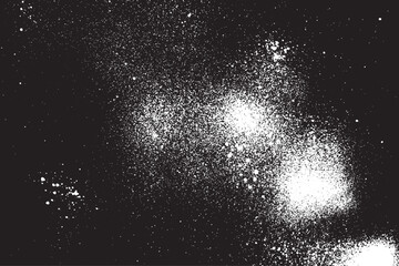 White spray paint exploding on black background creating abstract texture