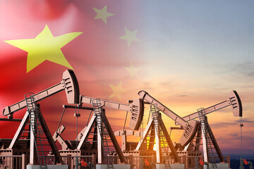Oil pumpjacks against the sunset with China flag. China Oil Industry concept