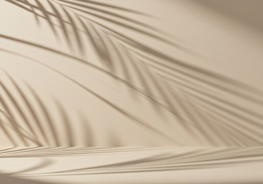 Shadow of palm leaves cast on a soft beige wall, creating a warm, fresh, aestetic, and minimal abstract background for product presentation.