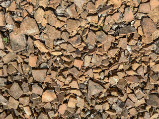 Discarded red broken roof tiles.