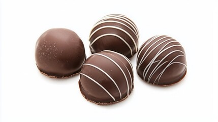 Obraz premium Chocolate dark fusion. Four decadent chocolate truffles with a glossy finish and elegant white stripes, arranged neatly on a clean, white background.