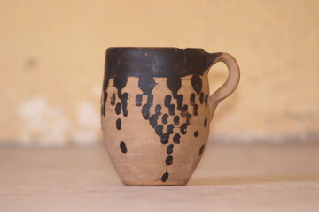 A close-up of handmade pottery cup