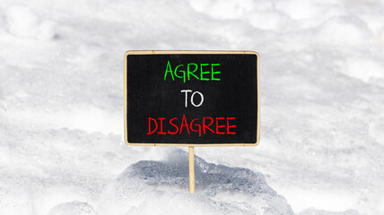 Agree to disagree symbol. Concept words Agree to disagree on beautiful blackboard. Beautiful white snow background. Business and agree to disagree concept. Copy space.