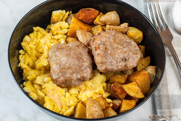 sausage patties with scramble eggs and home fries