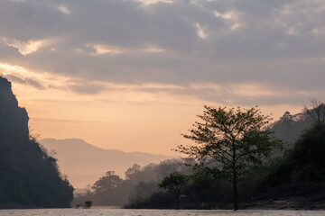 Misty Lake at Sunrise with Mountain Silhouette