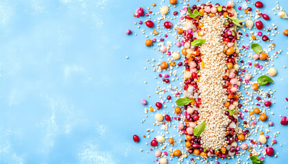 Obraz premium Vibrant quinoa and fruit bar, colorful healthy snack, overhead shot on blue background. Perfect for blogs, magazines, and websites.