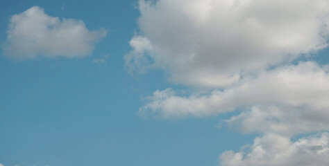 Clear blue sky, sunny day, soft white clouds, ideal peaceful background, weather-related concepts, sunlight shining brightly, calm soothing environment, expansive overhead view in thailand