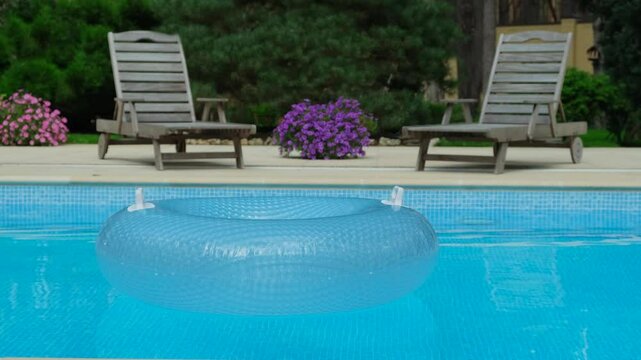 Relaxing by the Pool with Loungers and Inflatable Ring. Sunny Pool Day with Loungers and Inflatable Float. Relaxing Summer Day