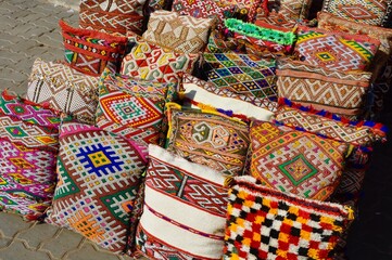 Colorful woven cushions at a stall in the old town of Marrakech, Morocco