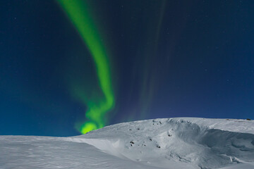 Aurora borealis, northern lights, over the hills around Kiruna, Lapland. Sweden.