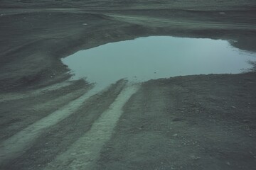 Fototapeta premium Puddle on Dusty Road