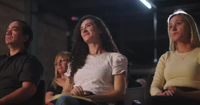 Diverse group of people attending a Christian church event, listening attentively to a speaker, engaged in spiritual reflection and community gathering