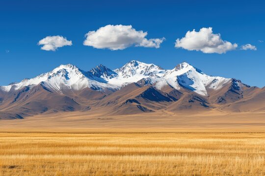 Majestic mountain range under blue sky and clouds